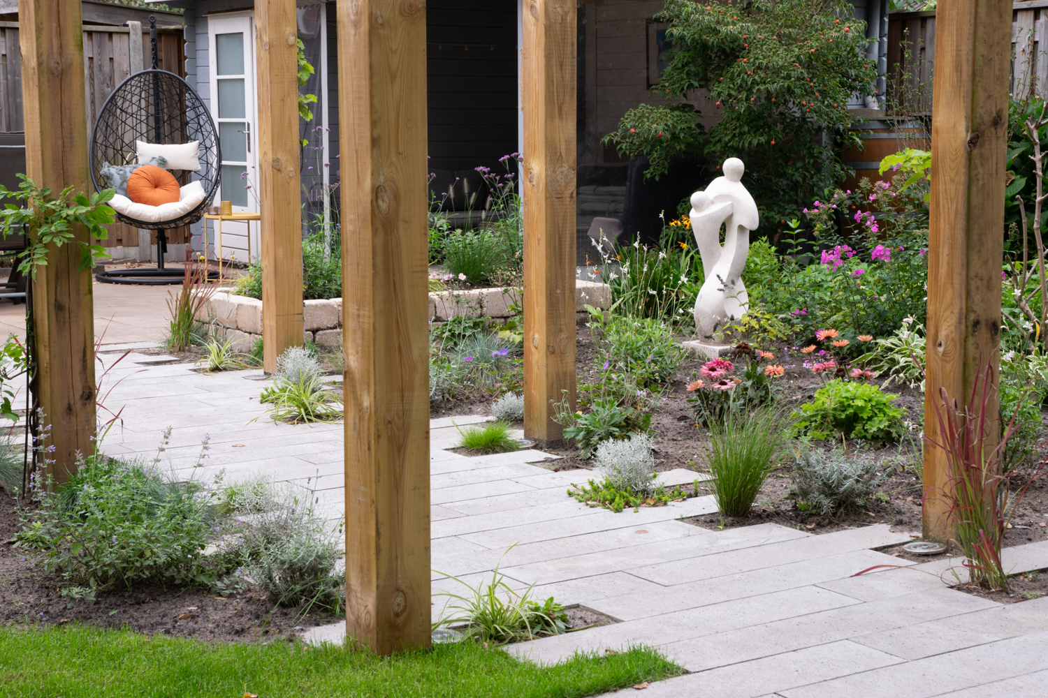 Bestrating in speels tuinontwerp met pergola 